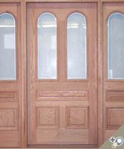 G121 / S14 entrance unit shown in solid Red Oak along with applied moldings, raised panels and insulated beveled glass.